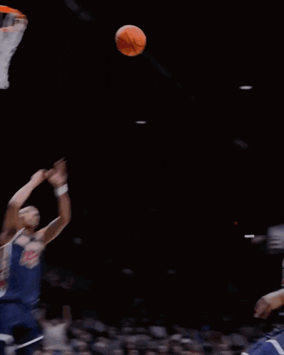 a basketball player with the number 23 on his jersey is dunking