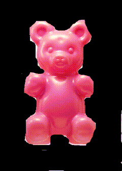 a pink gummy bear is against a black background