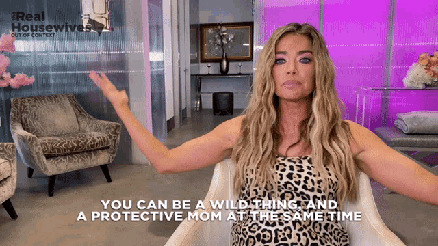 a woman in a leopard print dress says you can be a wild thing and a protective mom at same time