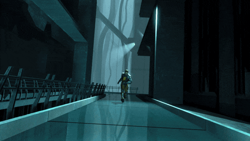 a man walking down a hallway with a fence behind him