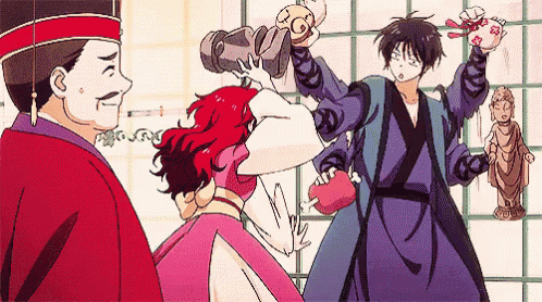 a man in a red hat is standing next to a woman in a pink dress and a man in a blue robe .
