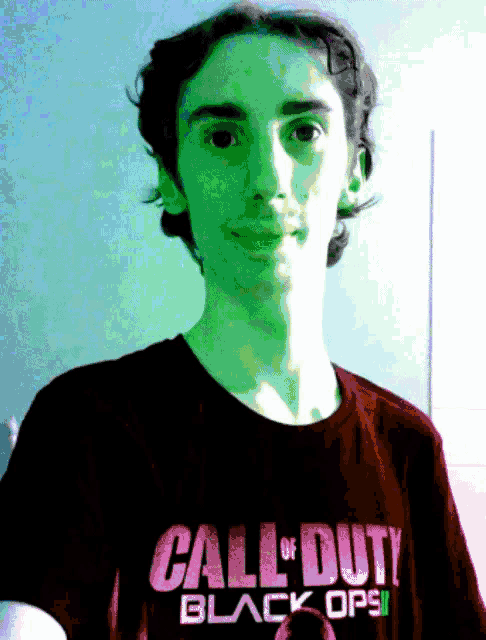 a young man is wearing a call of duty black ops t-shirt