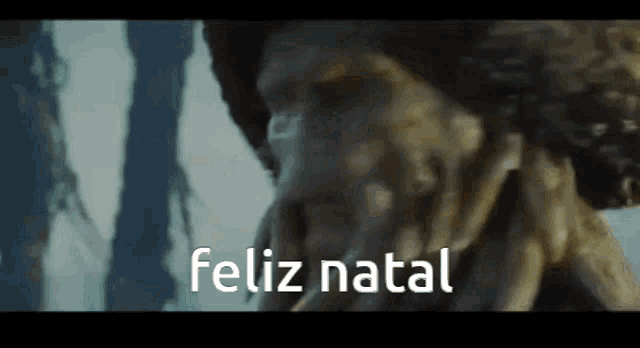a close up of a man 's face with the words feliz natal written below it