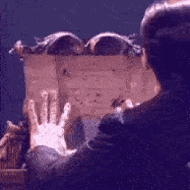 a person is putting their hands on a piece of wood