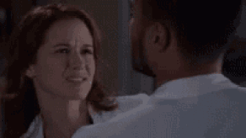 a man and a woman are standing next to each other and looking at each other .