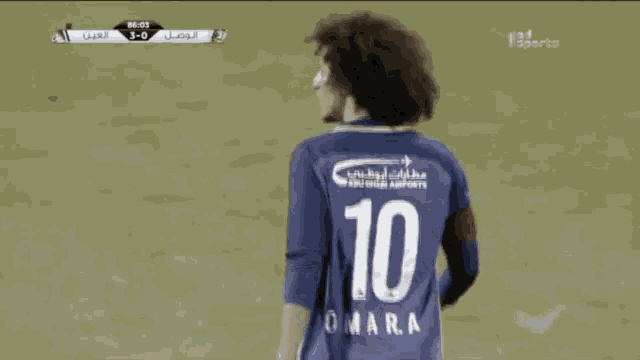 a soccer player wearing a blue jersey with the number 10 on the back