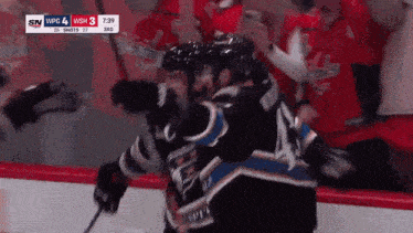 a hockey game is being played and the score is 3 to 0