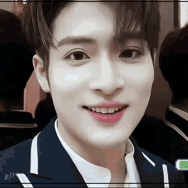 a close up of a young man 's face with a purple lip