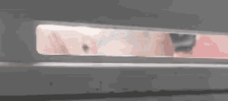a close up of a person 's face through a hole in a door .