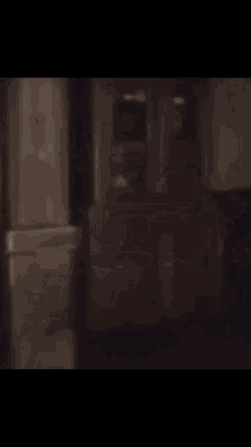 a blurred image of a person walking in a dark room