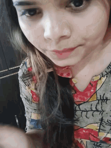 a close up of a woman 's face with a colorful shirt