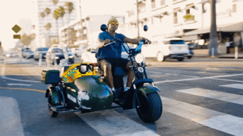 a man is riding a motorcycle with a sidecar that has a sign that says taxi