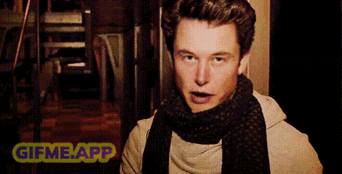 a man wearing a scarf and a sweater is being touched by another man .