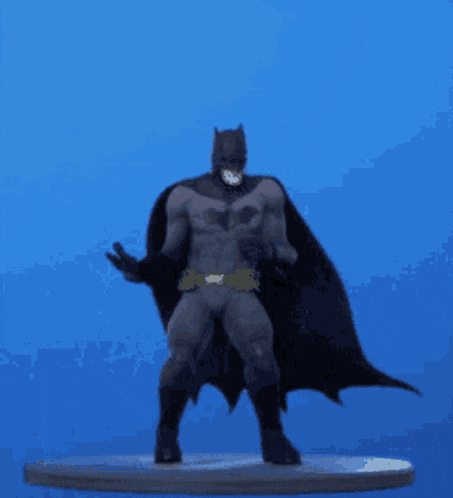 a batman figure is dancing on a blue background