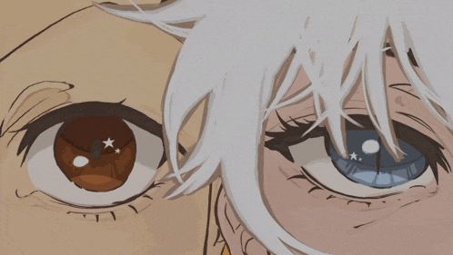 a close up of a person 's eyes with one being brown and the other being blue