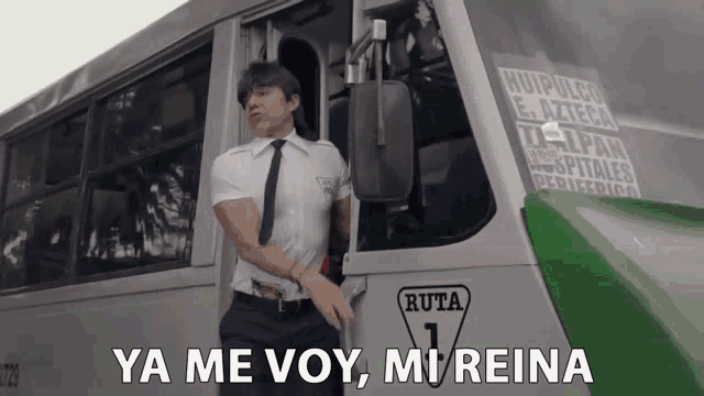 a man in a white shirt and tie stands in front of a bus that says ruta 1 on the side