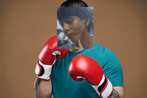 a man wearing red boxing gloves has a picture of a man behind him