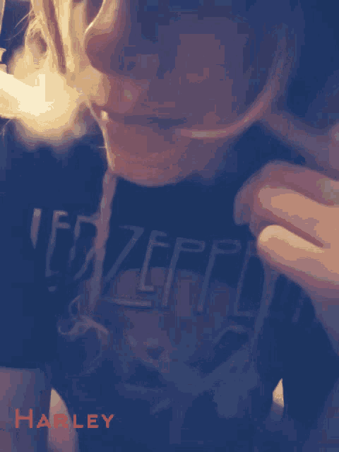 a person wearing a black shirt that says zeppelin