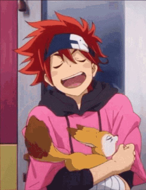 a boy with red hair is holding a dog in his arms and smiling .