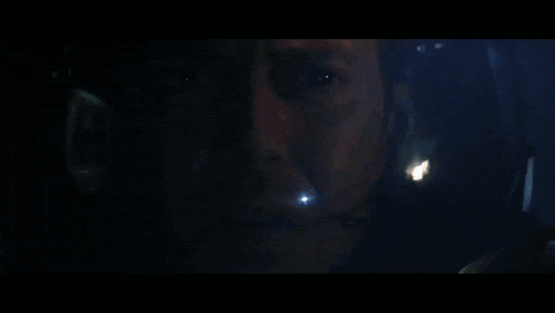 a close up of a man 's face wearing a helmet
