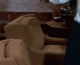 a person is standing in front of a couch and chairs