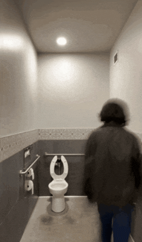 a blurred image of a person walking into a bathroom