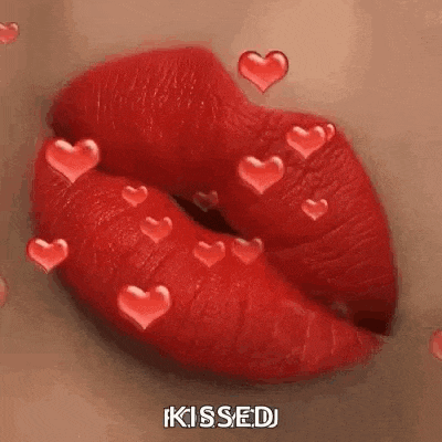 a close up of a woman 's lips with red lipstick and hearts floating around them .