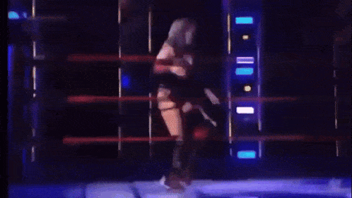 a woman is walking on a stage with the words ruby coat written on the screen behind her
