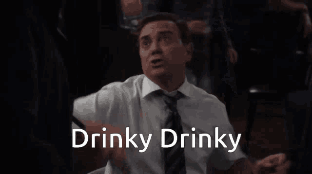 a man in a suit and tie says drinky drinky in front of him