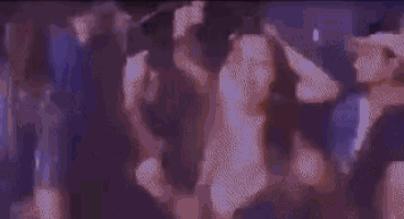 a blurry picture of a crowd of people dancing in a club