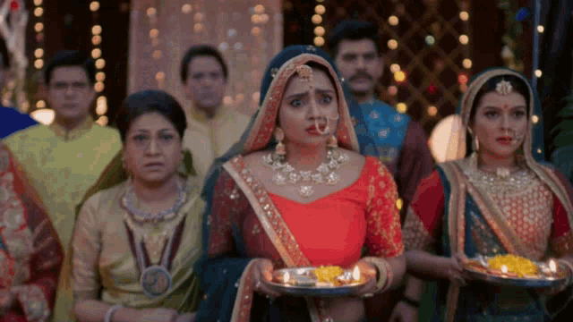 a woman with a nose ring is surrounded by other women