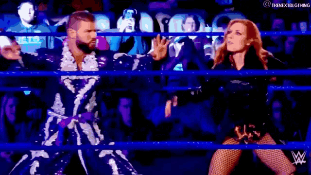 a man and a woman are dancing in a ring .