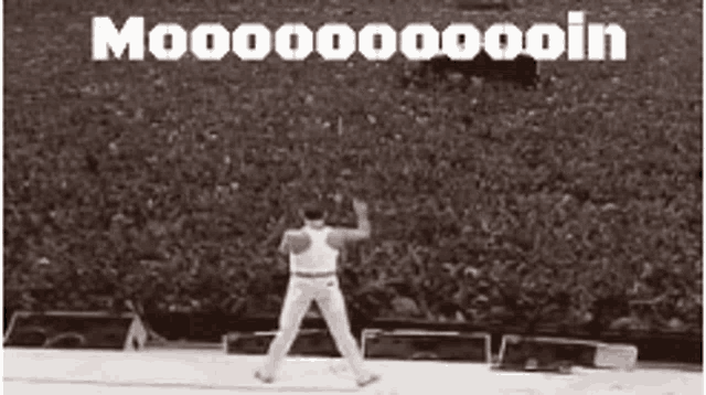 a black and white photo of a man dancing in front of a crowd with the words moooooooooin written on the bottom .