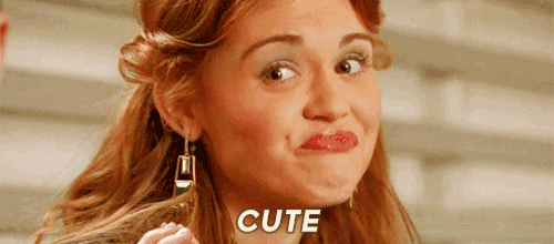 a woman wearing earrings is making a funny face and the word cute is on the bottom of the picture .