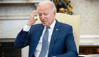 a man in a blue suit and tie is sitting in a chair .