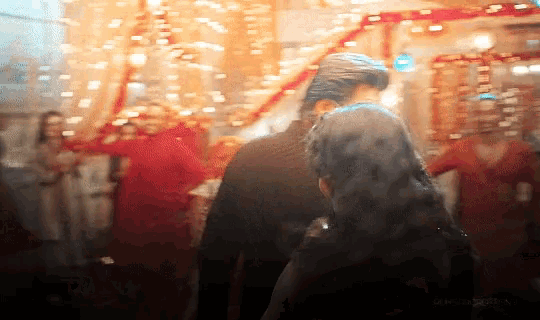 a blurry picture of a man and a woman in a room with a watermark that says ' amanda '