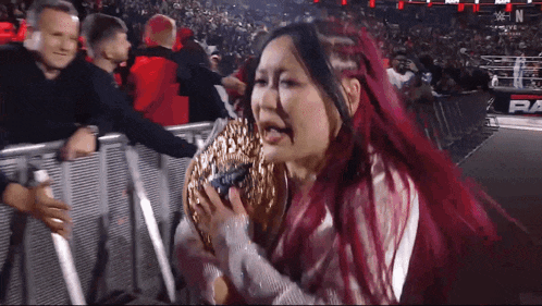 a woman with red hair is holding a doughnut in her hand