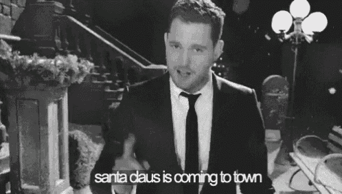 a man in a suit and tie is talking about santa claus