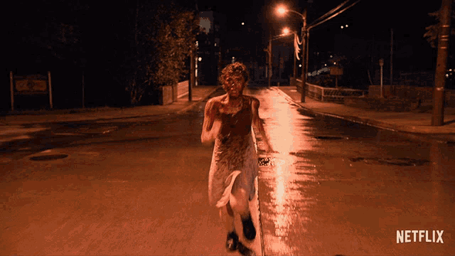 a bloody person is running down a street with a netflix logo in the corner