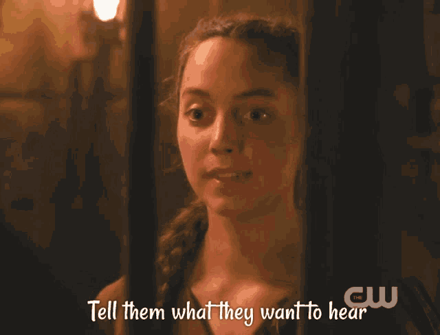 a woman behind bars with the words tell them what they want to hear below her