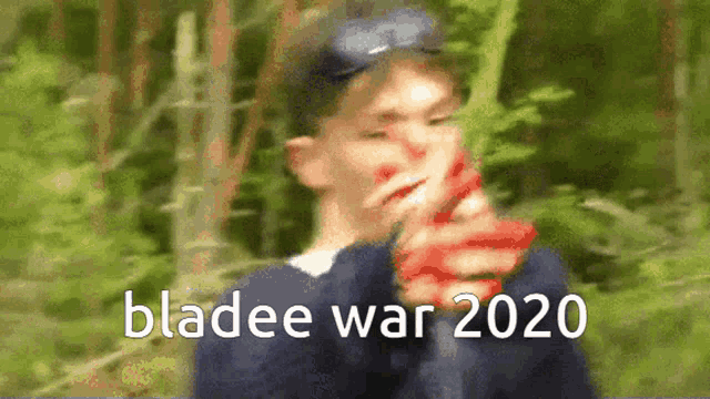 a blurry picture of a boy holding a gun with the words bladee war 2020 on the bottom