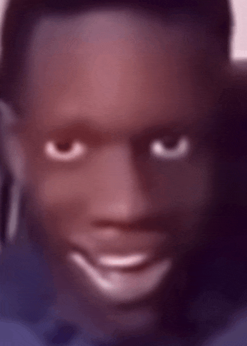 a blurry picture of a man 's face with a smile on his face .