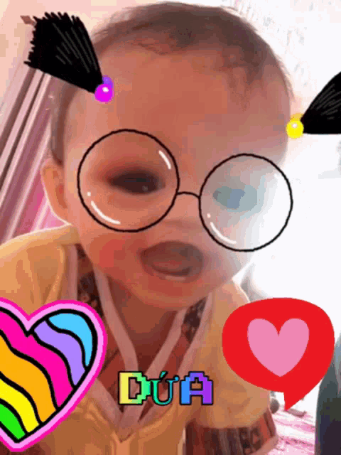 a baby wearing glasses and a heart with dua on it