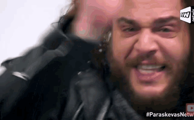 a man with a beard is making a funny face in a youtube video