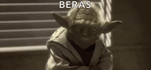 yoda from star wars is standing in front of a window with his arms crossed .