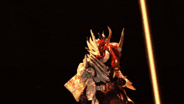 a statue of a man with horns and a sword is surrounded by flames