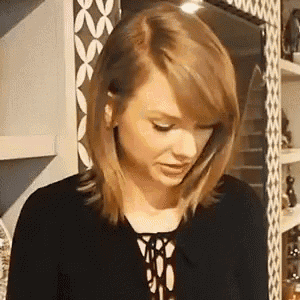 a close up of a woman 's face in a kitchen with a black shirt on .