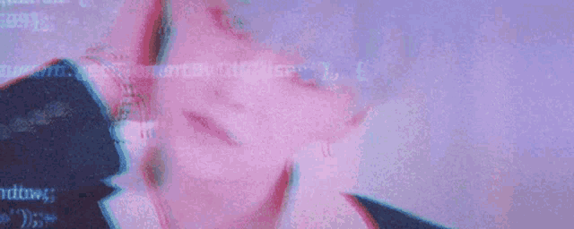 a woman 's face is being displayed on a computer screen with a glitch effect