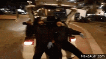 two people are dancing in the back of a car with makeagif.com at the bottom