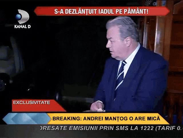 a man in a suit and tie is talking on a channel d news program